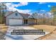 A model new construction home featuring a charming exterior and a two-car garage at 323 Nicole Dr, Temple, GA 30179