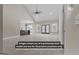 Spacious living room with vaulted ceilings, modern ceiling fan, and luxury vinyl flooring at 323 Nicole Dr, Temple, GA 30179