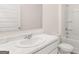 Bright bathroom features a marble countertop, a stylish mirror, and a clean, well-maintained shower-tub combo at 346 Friendship Oak Way, Hampton, GA 30228