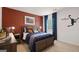 Bedroom with a red accent wall, basketball decor, bedside lamps, and wood furniture at 346 Friendship Oak Way, Hampton, GA 30228