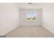 Spacious bedroom with a large window and neutral carpet at 346 Friendship Oak Way, Hampton, GA 30228