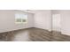 Open bedroom with hardwood floors and a large window at 346 Friendship Oak Way, Hampton, GA 30228