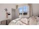 Delicate bedroom with a window view, featuring chic decor and ample natural light at 346 Friendship Oak Way, Hampton, GA 30228