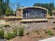 Community sign for Oakchase at Hampton with brick base and landscaping at 346 Friendship Oak Way, Hampton, GA 30228
