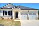 Charming single-Gathering home featuring a 2-car garage, neutral paint, and a welcoming front entrance at 346 Friendship Oak Way, Hampton, GA 30228