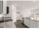 Bright kitchen featuring modern appliances, light cabinets, granite countertops, and wood floors at 346 Friendship Oak Way, Hampton, GA 30228