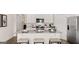 Well-equipped kitchen with stainless steel appliances, granite countertops, and white cabinets for a clean look at 346 Friendship Oak Way, Hampton, GA 30228