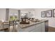 Granite kitchen island with sink and dishwasher open to the living and dining area at 346 Friendship Oak Way, Hampton, GA 30228