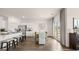 Open-concept kitchen and dining area boasts stainless appliances and island seating at 346 Friendship Oak Way, Hampton, GA 30228