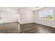 Bright living room featuring hardwood floors, a ceiling fan and a large window at 346 Friendship Oak Way, Hampton, GA 30228