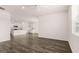 Open-concept living room with hardwood floors and view into the kitchen at 346 Friendship Oak Way, Hampton, GA 30228