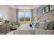 Comfortable main bedroom featuring a large window, soft decor, and stylish furnishings at 346 Friendship Oak Way, Hampton, GA 30228