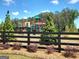 Community playground featuring a fenced area with newer play structures and mature trees at 346 Friendship Oak Way, Hampton, GA 30228