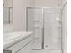 Modern bathroom with a streamlined shower featuring glass doors and built-in shelving at 346 Friendship Oak Way, Hampton, GA 30228