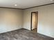Cozy bedroom featuring dark wood-look floors and neutral walls, perfect for relaxation and personalization at 30 Alyssa Ln, Bowdon, GA 30108