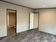 Large bedroom showing hardwood floors, neutral walls, and multiple doorways at 30 Alyssa Ln, Bowdon, GA 30108