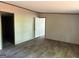 Bright bedroom featuring wood-look floors, neutral walls, and doorways to the rest of the home at 30 Alyssa Ln, Bowdon, GA 30108