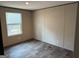 Bright bedroom featuring hardwood floors and a view of the outdoors through a window at 30 Alyssa Ln, Bowdon, GA 30108
