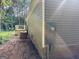 Exterior side view of home showing siding and deck, nestled in a private wooded lot with lush green surroundings at 30 Alyssa Ln, Bowdon, GA 30108