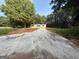 Exterior view of home on expansive lot with long driveway surrounded by lush greenery on a sunny day at 30 Alyssa Ln, Bowdon, GA 30108