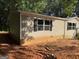 Side view of a tan single-story house with siding and a block foundation at 30 Alyssa Ln, Bowdon, GA 30108