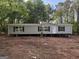 Charming one-story home with neutral siding and dark window shutters at 30 Alyssa Ln, Bowdon, GA 30108