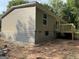 Back of house showing siding, block foundation, and small wooden deck at 30 Alyssa Ln, Bowdon, GA 30108