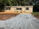 Single-story home featuring new gravel driveway, tan siding, and black shutters at 30 Alyssa Ln, Bowdon, GA 30108
