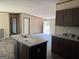Open kitchen with island, ample counter space, and modern finishes in neutral tones at 30 Alyssa Ln, Bowdon, GA 30108