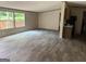 Expansive living area with wood-look floors, connecting seamlessly to the kitchen and natural light at 30 Alyssa Ln, Bowdon, GA 30108