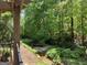 Scenic view from a porch overlooking a creek surrounded by lush trees and greenery at 3108 Westchester Ne Rdg, Atlanta, GA 30329