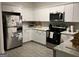 Well-lit kitchen with stainless steel appliances, white cabinets, and a tiled backsplash at 3108 Westchester Ne Rdg, Atlanta, GA 30329