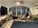 Inviting living room featuring a plush sectional sofa, recliner chairs, stylish decor, and ceiling fan at 3108 Westchester Ne Rdg, Atlanta, GA 30329