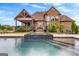 View of the backyard pool, deck, and covered patio perfect for backyard entertaining at 770 Tralee Dr, Fayetteville, GA 30215