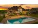 Aerial view of backyard swimming pool, deck, and covered patio at sunset at 770 Tralee Dr, Fayetteville, GA 30215