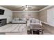 Basement living room with soft lighting, two sofas, a decorative rug, and ceiling fan at 770 Tralee Dr, Fayetteville, GA 30215