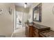 Bathroom featuring a wooden vanity with a granite countertop and an adjacent office space at 770 Tralee Dr, Fayetteville, GA 30215
