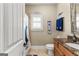 A sporty bathroom featuring a granite vanity, a toilet, and baseball-themed decor at 770 Tralee Dr, Fayetteville, GA 30215