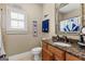 A sporty bathroom featuring a granite vanity, a toilet, and baseball-themed decor at 770 Tralee Dr, Fayetteville, GA 30215