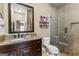 Bathroom boasts a granite vanity, a toilet, and a frameless glass shower at 770 Tralee Dr, Fayetteville, GA 30215