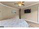Bedroom featuring a comfortable bed with a decorative quilt, and a large wall-mounted television at 770 Tralee Dr, Fayetteville, GA 30215