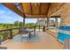 Covered outdoor deck with dining set and view of the brick home at 770 Tralee Dr, Fayetteville, GA 30215