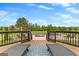 Deck with outdoor lounge chairs overlooking a pool and scenic landscape at 770 Tralee Dr, Fayetteville, GA 30215