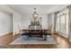 Elegant dining room features a wooden table with chairs, chandelier, and large window at 770 Tralee Dr, Fayetteville, GA 30215