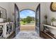 Entryway featuring double wrought iron doors with a view of the front lawn and neighborhood at 770 Tralee Dr, Fayetteville, GA 30215