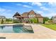 A stunning brick home with a backyard pool, covered patio, and well-manicured landscaping at 770 Tralee Dr, Fayetteville, GA 30215