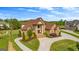 Impressive stone home with a grand entrance, manicured lawn, circular driveway, and mature landscaping at 770 Tralee Dr, Fayetteville, GA 30215