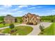 Expansive home with circular driveway and lush lawn showcasing its grand presence at 770 Tralee Dr, Fayetteville, GA 30215