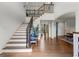 Spacious two-story foyer with staircase, hardwood floors, bench and view to other rooms at 770 Tralee Dr, Fayetteville, GA 30215
