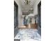 Grand two-story foyer features hardwood floors, coffered ceilings, and elegant staircase with iron railings at 770 Tralee Dr, Fayetteville, GA 30215
